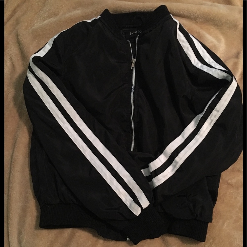 Black jacket with stripe along side of arms